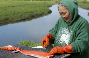 Woman cutting fish